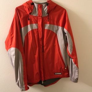REI women's L rain jacket in orange and grey